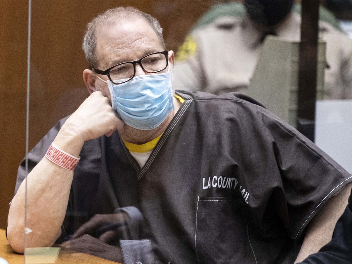 FILE - Harvey Weinstein, the 69-year-old convicted rapist and disgraced movie mogul, wears a face mask behind a protective plexiglass screen as he listens in court during a pre-trial hearing in Los An ...