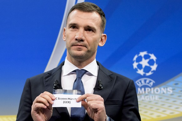 Former Ukrainian soccer player and ambassador for the UEFA Champions League final in Kiev, Andriy Shevchenko, shows a ticket with German soccer team &quot;FC Bayern Muenchen&quot; during the quarterfi ...