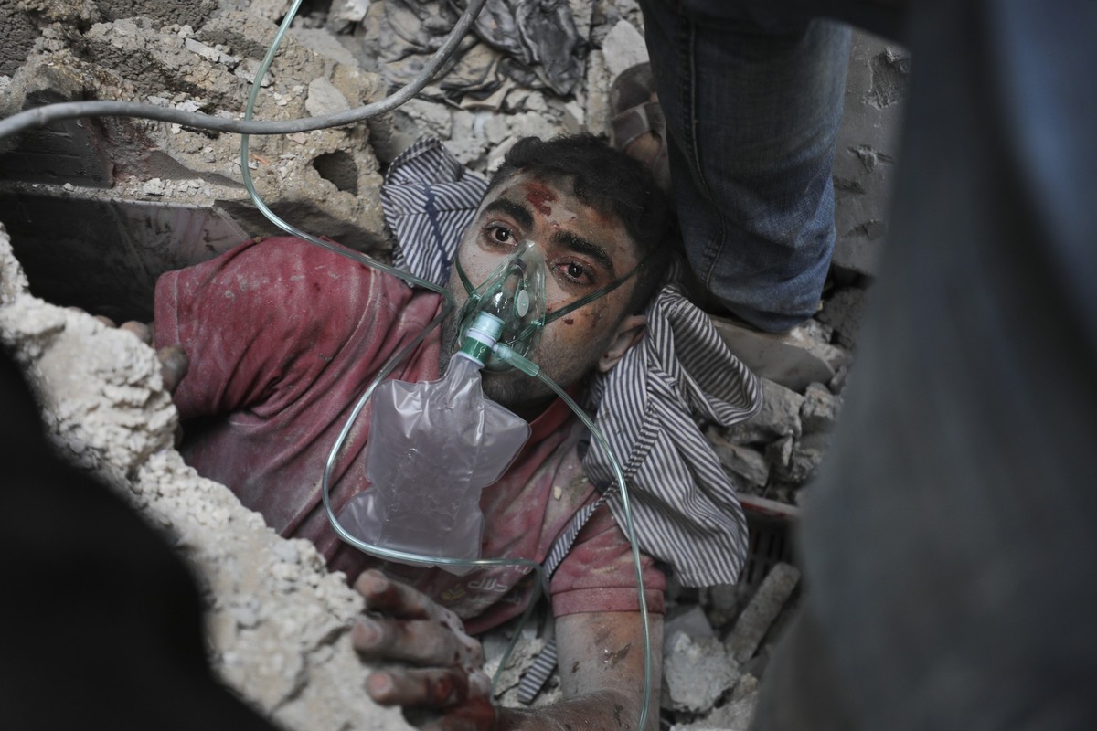 Palestinians rescue a survivor of Israeli bombardment of the Gaza Strip in Nusseirat refugee camp, Tuesday, Oct. 24, 2023. (AP Photo/Ali Mohmoud)