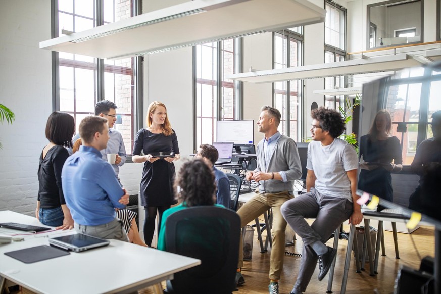 Multi-ethnic business people sharing ideas in a modern office. Group of professionals discussing new business plan in meeting.