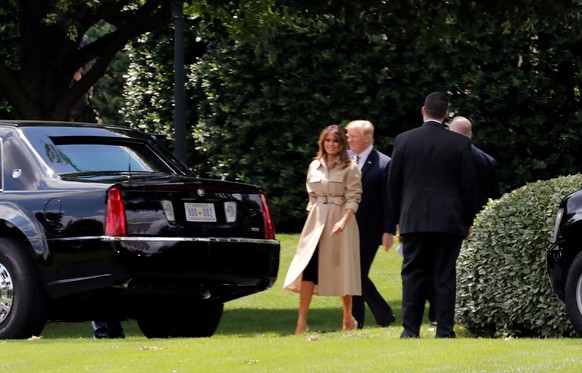 U.S. first lady Melania Trump heads to the presidential limo with President Donald Trump as they depart for their first public appearance together in almost a month from the White House in Washington, ...