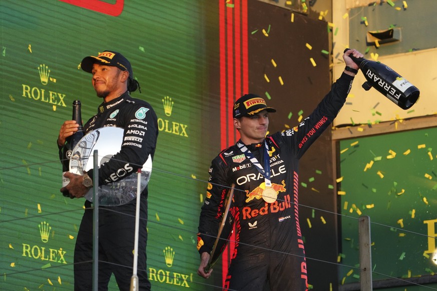 Red Bull driver Max Verstappen of Netherlands, right, and Mercedes driver Lewis Hamilton of Britain celebrate on the podium after the Australian Formula One Grand Prix at Albert Park in Melbourne, Sun ...