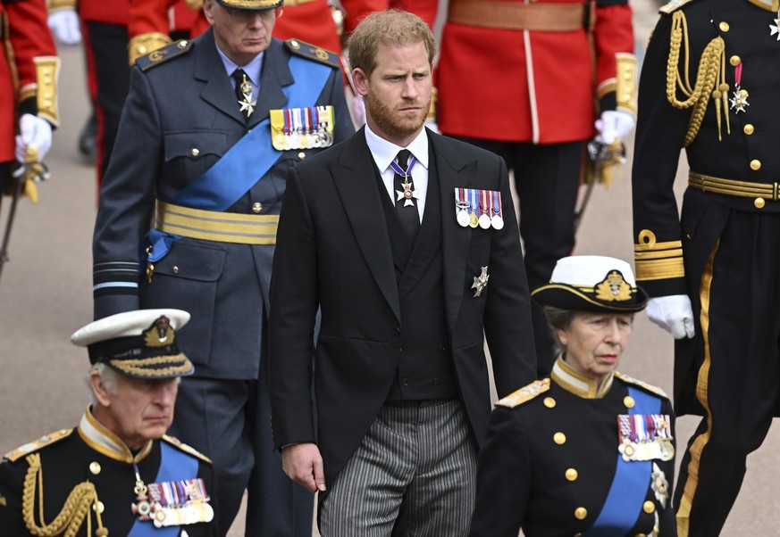 King Charles III, Prince Harry and Princess Anne follow the State Hearse carrying the coffin of Queen Elizabeth II, draped in the Royal Standard with the Imperial State Crown and the Sovereign&#039;s  ...