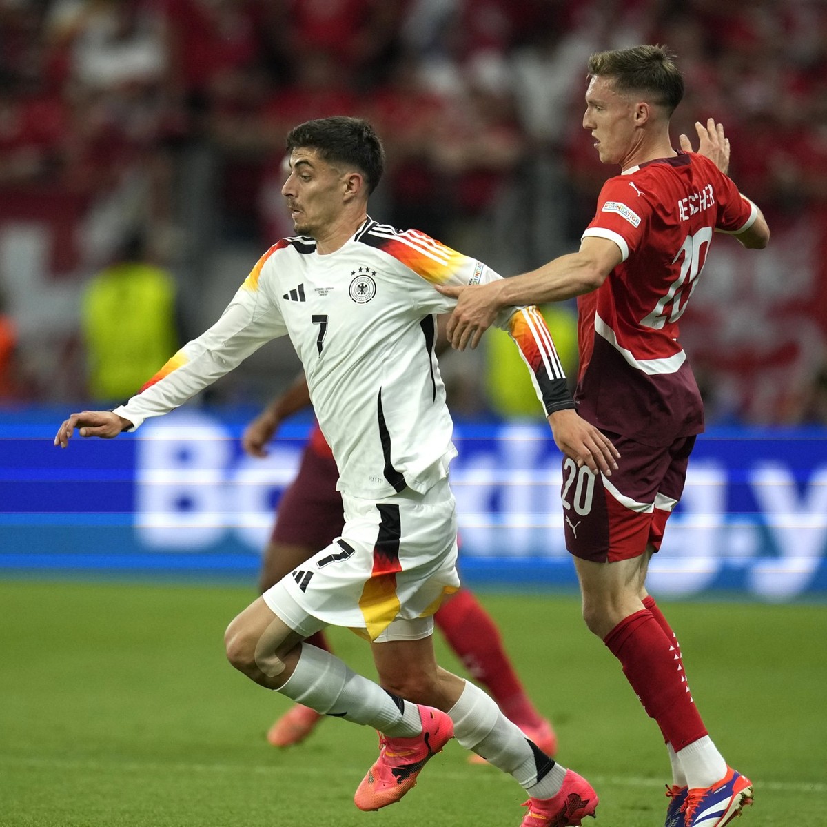 Switzerland&#039;s Michel Aebischer, right, challenges Germany&#039;s Kai Havertz, left, during a Group A match between Switzerland and Germany at the Euro 2024 soccer tournament in Frankfurt, Germany ...
