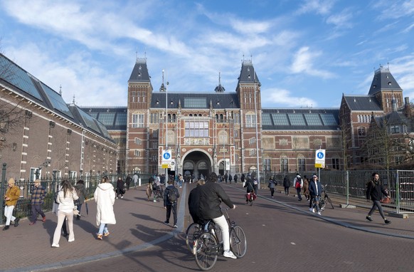 Amsterdam The Netherlands 29th January 2022 Cyclists head under the tunnel of the Rijksmuseum on a sunny day. Probably the best known art museum in The Netherlands the museum is probably best known fo ...