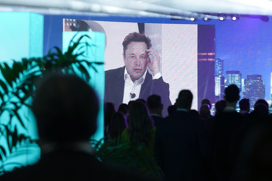 Twitter CEO Elon Musk is broadcast on a screen as he speaks at the POSSIBLE marketing conference, Tuesday, April 18, 2023, in Miami Beach, Fla. (AP Photo/Rebecca Blackwell)