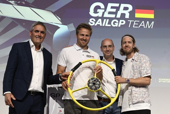 31.05.2023, Nordrhein-Westfalen, Düsseldorf: Segel-Ikone Sir Russell Coutts (l-r), Segler Erik Heil, Sponsor Thomas Riedel und der ehemalige deutsche Formel1-Weltmeister Sebastian Vettel bei der Bekan ...