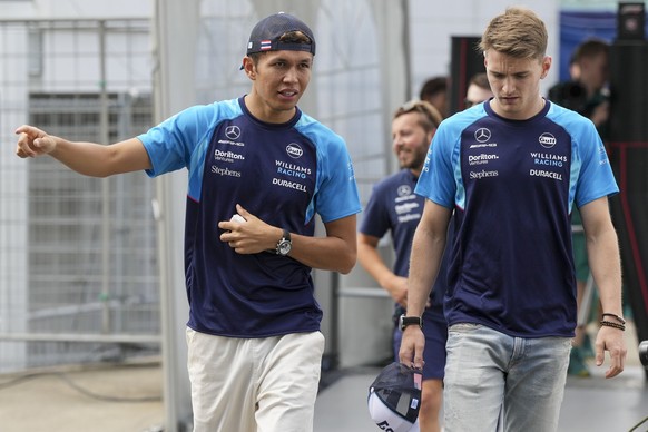 Williams drivers Alexander Albon of Thailand, left, and Logan Sargeant of the US walk through paddock before the first practice ahead of the Japanese Formula One Grand Prix at the Suzuka Circuit, Suzu ...
