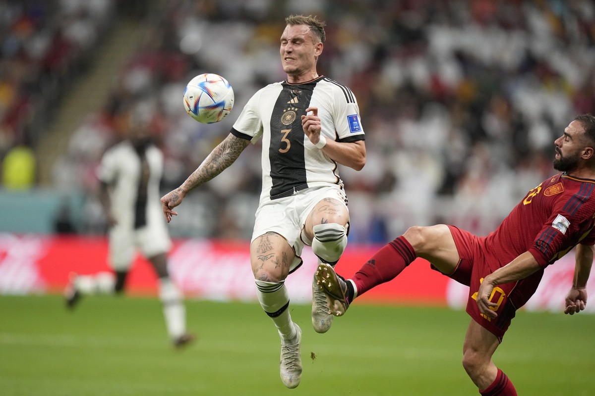 Spain&#039;s Dani Carvajal, right, tries to tackle Germany&#039;s David Raum during the World Cup group E soccer match between Spain and Germany, at the Al Bayt Stadium in Al Khor , Qatar, Sunday, Nov ...