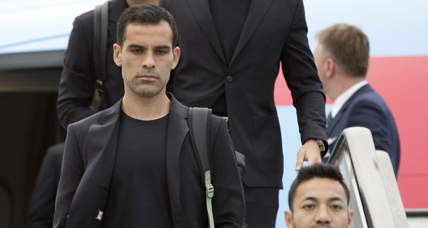 Rafael Marquez, center, and his teammates disembark the plane as the Mexico national soccer team arrive at the Sheremetyevo international airport, outside Moscow, Russia, Monday, June 11, 2018 to comp ...