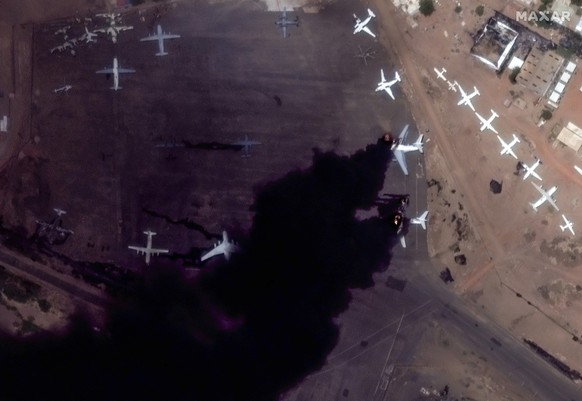 dpatopbilder - HANDOUT - 16.04.2023, Sudan, Khartum: Dieses von Maxar Technologies via AP zur Verfügung gestellte Satellitenbild zeigt zwei brennende Flugzeuge auf dem internationalen Flughafen von. I ...