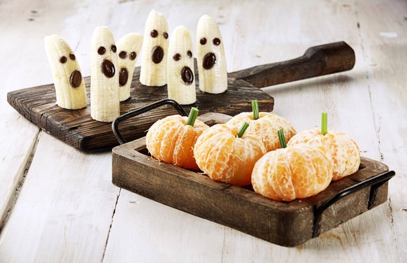 Healthy Fruit Halloween Treats made into Banana Ghosts and Clementine Orange Pumpkins