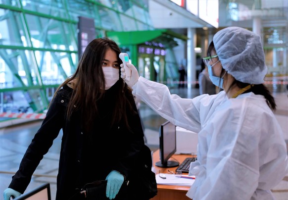 200501 -- NUR-SULTAN, May 1, 2020 Xinhua -- A staff member checks a passenger s temperature at Nursultan Nazarbayev International Airport in Nur-Sultan, Kazakhstan, on May 1, 2020. Kazakhstan has resu ...