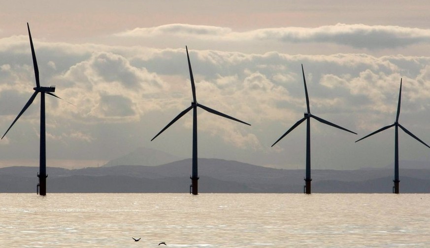 LIVERPOOL, UNITED KINGDOM - OCTOBER 18: Turbines of the new Burbo Bank off shore wind farm adorn the skyline in the mouth of the River Mersey after their official inauguration today on October 18, 200 ...