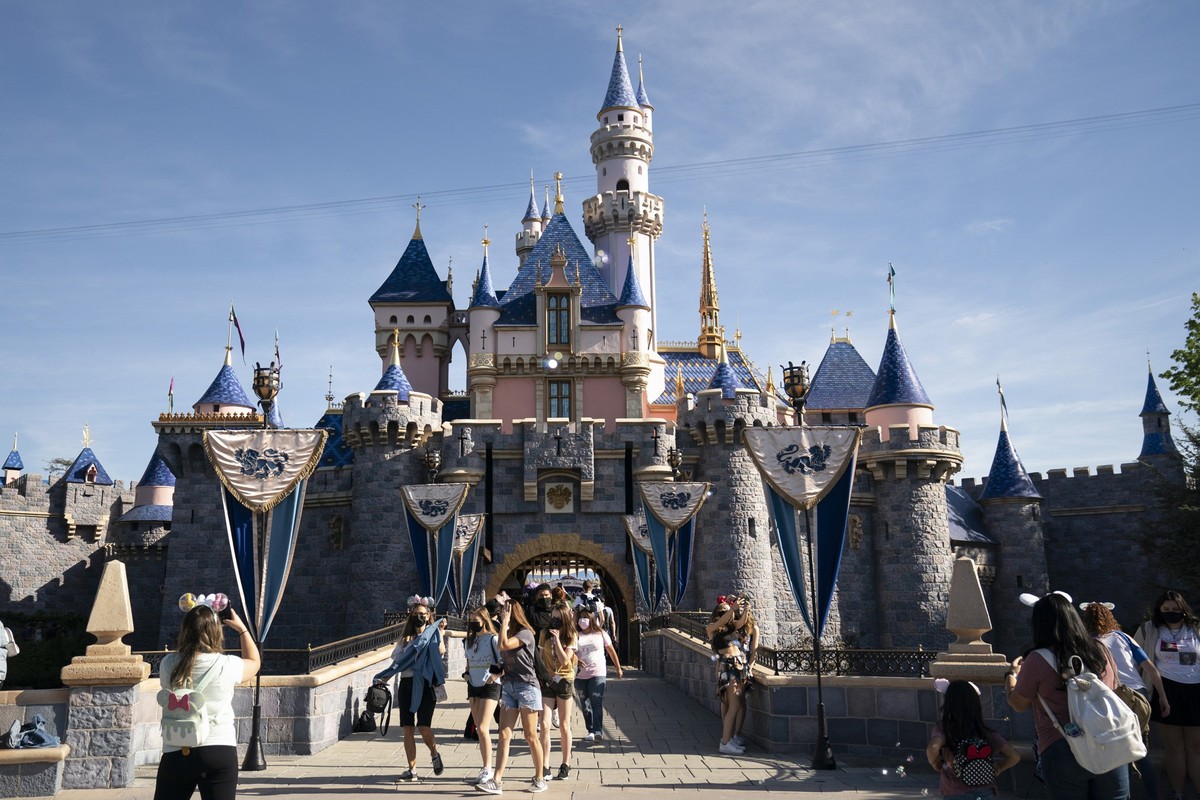 FILE - Visitors pass through Disneyland in Anaheim, Calif., on April 30, 2021. Disney has received a key approval to expand its Southern California theme parks in its first push to make major changes  ...