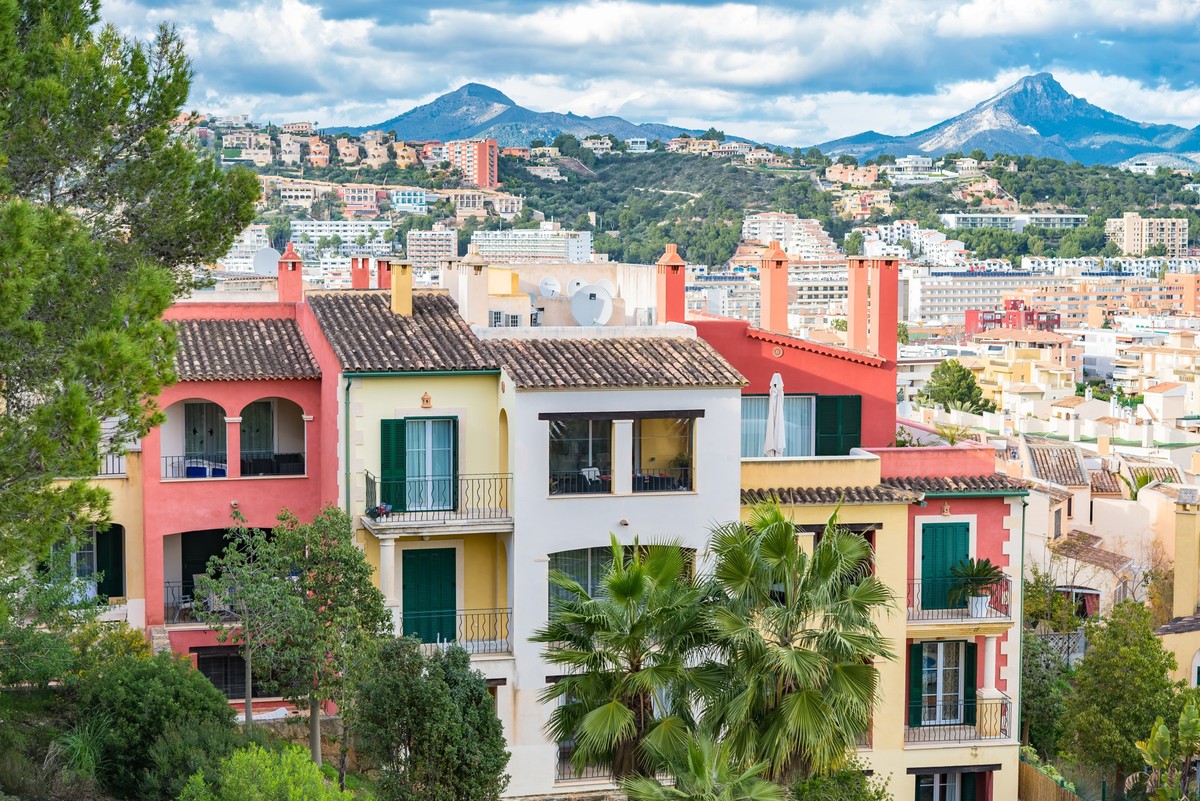 A landscape of modern cottages surrounded by buildings and greenery in Santa Ponsa, Majorca, Spain 826142 RECORD DATE NOT STATED