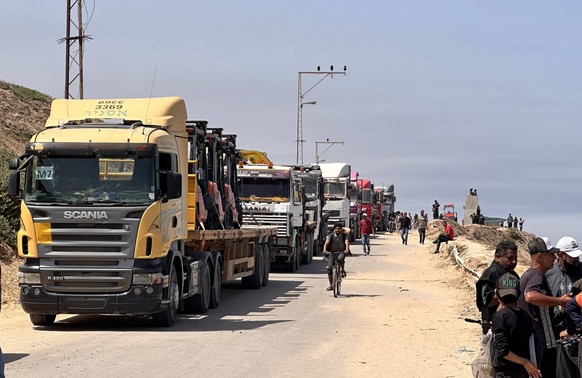 Trucks gather near Wadi Gaza, waiting to be allowed to enter the floating dock established by the United States of America on the shore of Gaza Trucks gather near Wadi Gaza, waiting to be allowed to e ...