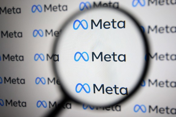 Facebook Renames Itself To Meta Meta Platforms Inc. logo is pictured through a magnifying glass in this illustrative photo taken in Kyiv on 29 October, 2021. Facebook renames itself to new company bra ...