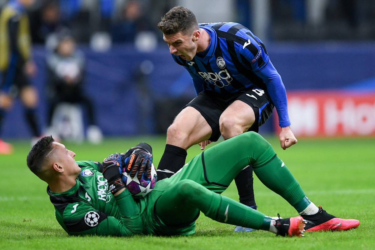 Robin Gosens of Atalanta celebrates Pierluigi Gollini of Atalanta after he saved on Maxi Gomez of Valencia during the UEFA Champions League Round of 16 match between Atalanta and Valencia at Stadio Sa ...
