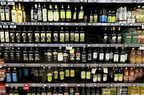 Olive oil bottles are seen in a supermarket in Rome, Friday, March 8, 2024. One-third of Italians have reduced their consumption of extra virgin olive oil due to skyrocketing prices, according to a su ...