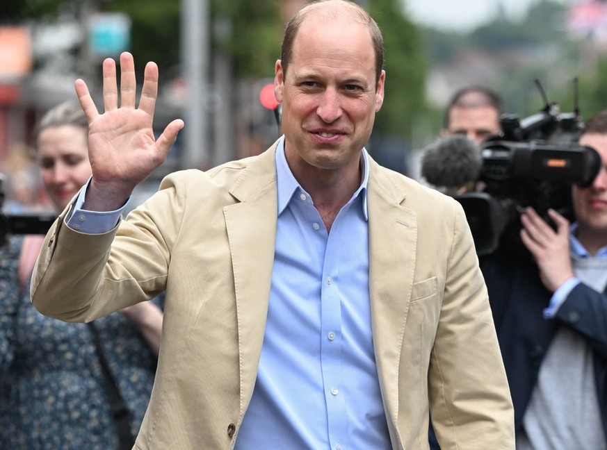 BELFAST, NORTHERN IRELAND - JUNE 27: Prince William, Prince of Wales waves to the public after his visit to the East Belfast Mission at the Skainos Centre as part of his tour of the UK to launch a pro ...