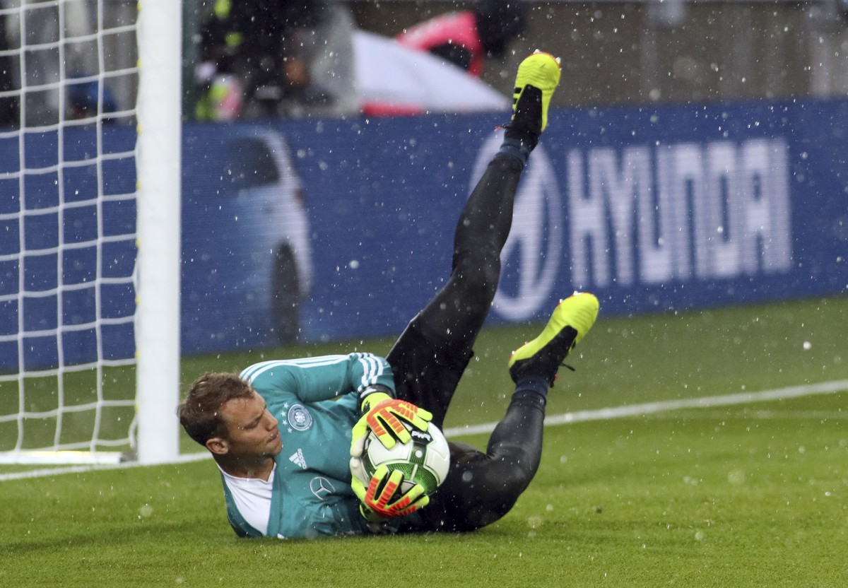 Germany goalkeeper Manuel Neuer catches a ball as hail falls during warmup before a friendly soccer match between Austria and Germany in Klagenfurt, Austria, Saturday, June 2, 2018. (AP Photo/Ronald Z ...