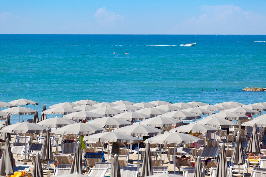 long rows of beach umbrellas and beds in Rimini, Emilia RomagnaOTHER BEACH SCENES FROM ITALY: