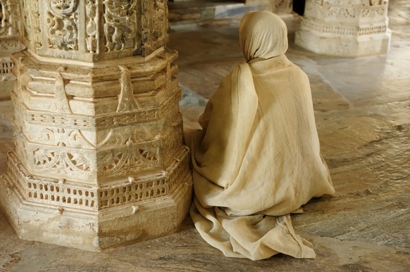 Viewof praying monk inside the Jain Temple in Ranagpur, Rajasthan, India