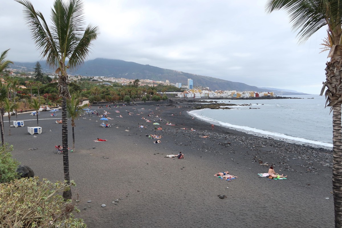 Jardin beach, Puerto de la Cruz, Tenerife, Spain, May 27, 2022: The quiet Jardin beach with volcanic black sand in the Atlantic ocean, Puerto de la Cruz, Tenerife, Spain
