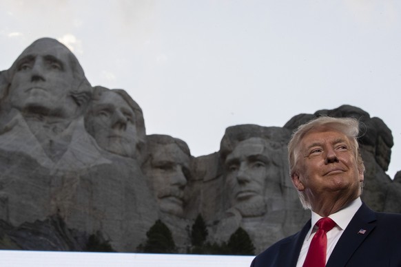 FILE - Then-President Donald Trump stands at Mount Rushmore National Memorial on July 3, 2020, near Keystone, S.D. South Dakota prosecutors have dropped all charges against the head of an Indigenous-l ...