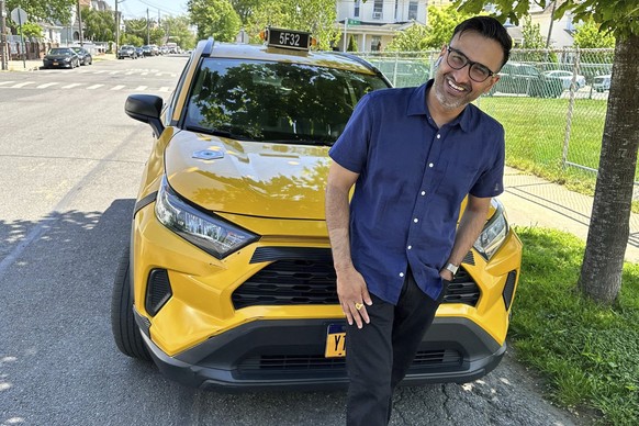 New York City cab driver Sukhcharn Singh poses for a photo with his taxi in the Queens borough of New York, Wednesday, May 17, 2023. Prince Harry and his wife, Meghan, were pursued in their car by pho ...