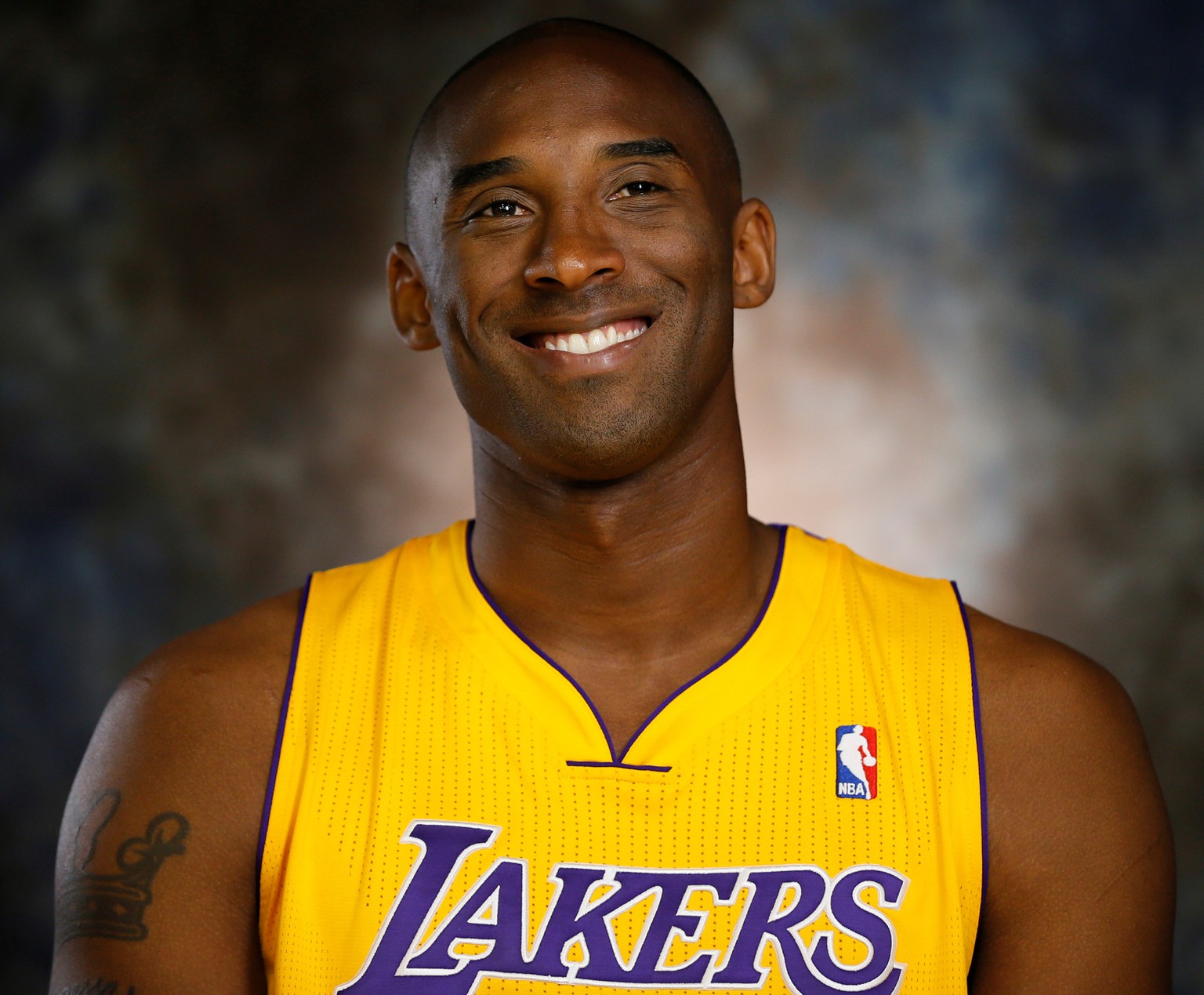 FILE PHOTO: Lakers guard Kobe Bryant smiles during an interview at NBA media day for the Los Angeles Lakers basketball team in Los Angeles October 1, 2012. REUTERS/Lucy Nicholson/File Photo