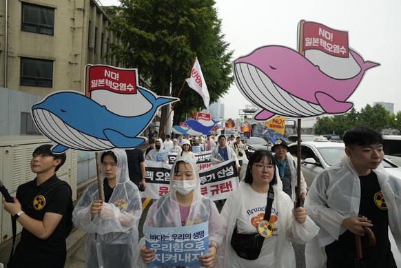 Protesters march during a rally against Japanese government&#039;s plan to release treated radioactive water from Fukushima nuclear power plant, in Seoul, South Korea, Saturday, July 15, 2023. The red ...