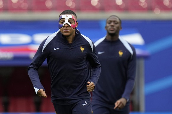 Il francese Kylian Mbappe indossa una maschera mentre si allena con i suoi compagni di squadra durante una sessione di allenamento a Lipsia, in Germania, giovedì 20 giugno 2024. La Francia giocherà contro l'Olanda durante la Coppa del mondo.