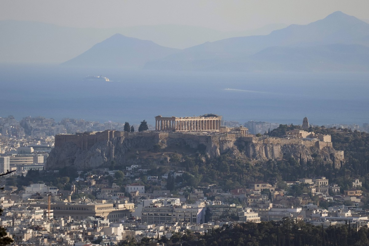 Acropolis Of Athens Panoramic view of the Parthenon and the Acropolis of Athens seen from a hill with the city and the sea in the background. The ancient temple and the surrounding buildings like Temp ...