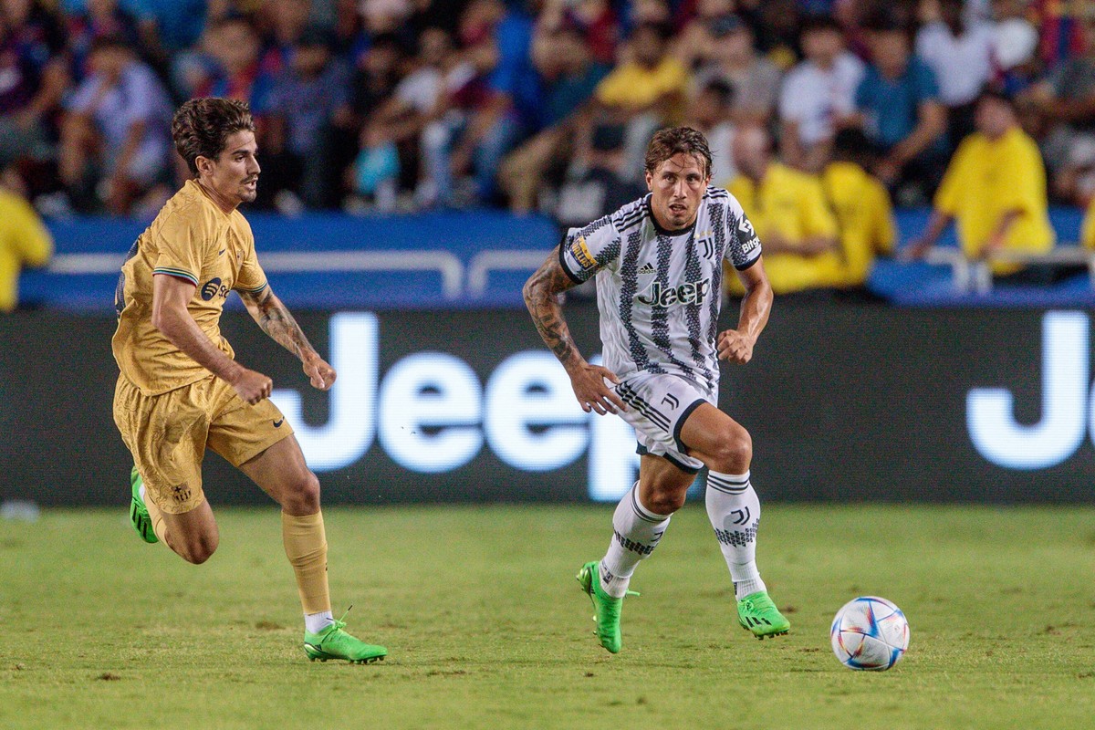 Juventus defender Luca Pellegrini (17) drives the ball up field around a defender during the game against Barcelona