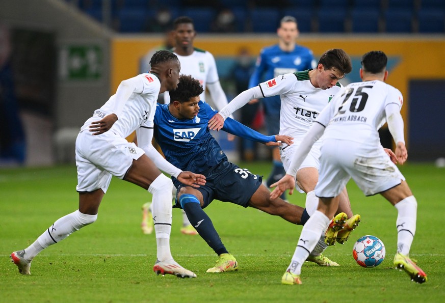 SINSHEIM, GERMANY - DECEMBER 18: Georginio Rutter of TSG 1899 Hoffenheim (C) is challenged by Joe Scally and Ramy Bensebaini of Borussia Moenchengladbach during the Bundesliga match between TSG Hoffen ...