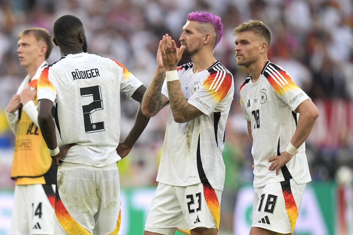 From left, Germany&#039;s Antonio Ruediger, Germany&#039;s Robert Andrich and Germany&#039;s Maximilian Mittelstadt react at the end of a quarter final match between Germany and Spain at the Euro 2024 ...