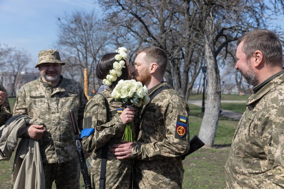 April 7, 2022, Kyiv, Ukraine: The newlywed members of the Kyiv Territorial Defense shared a kiss during their wedding amidst the ongoing war. Members of the Kyiv Territorial Defense, Anastasiia Mokhin ...