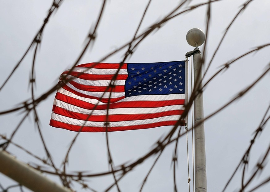 An American Flag is seen through razor wire at Camp VI in Camp Delta where detainees are housed at Naval Station Guantanamo Bay in Cuba on July 8, 2010. PUBLICATIONxINxGERxSUIxAUTxHUNxONLY GTMO2010070 ...