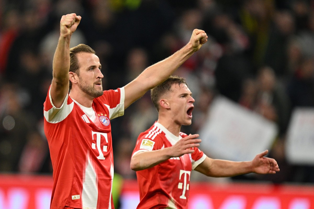 Bayern&#039;s Harry Kane, left, and Bayern&#039;s Joshua Kimmich celebrate their victory at the Bundesliga soccer match between Bayern Munich and Borussia Dortmund in Munich, Germany, Saturday, Oct. 1 ...