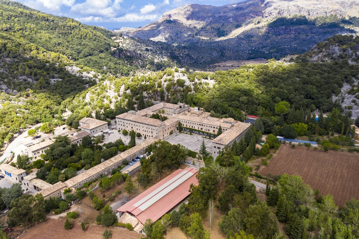 Spain, Mallorca, Escorca, Helicopter view of Santuari de Lluc in forested valley of Serra de Tramuntana range AMF08777