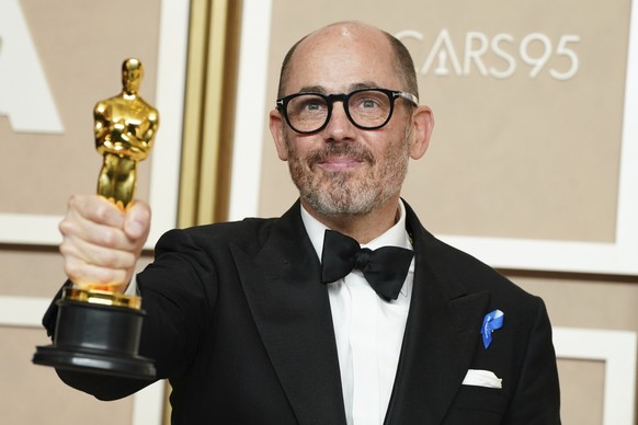 Edward Berger, winner of the award for &quot;All Quiet on the Western Front&quot; from Germany, for best international feature film, poses in the press room at the Oscars on Sunday, March 12, 2023, at ...