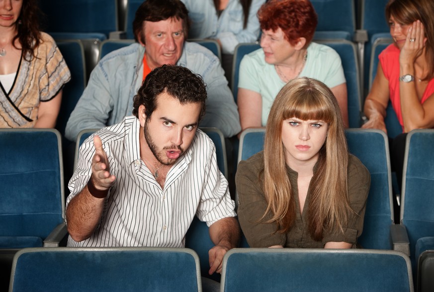 Serious movie fans angry in a theater