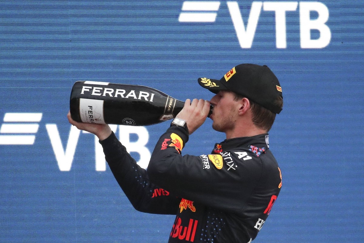 SOCHI, RUSSIA - SEPTEMBER 26, 2021: 2nd placed, Red Bull Racing F1 Team driver Max Verstappen drinks champagne during the podium ceremony for the 2021 Formula One Russian Grand Prix at the Sochi Autod ...