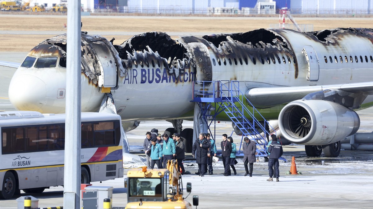Mayor of Busan Park Heong-joon and other officials visit the site where an Air Busan airplane caught fire at Gimhae International Airport in Busan, South Korea, Wednesday, Jan. 29, 2025. (Son Hyung-jo ...