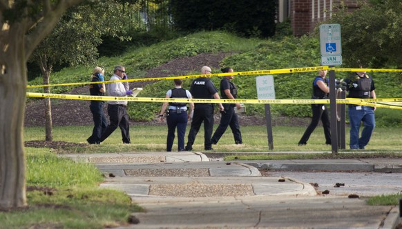 Police work the scene where eleven people were killed during a mass shooting at the Virginia Beach city public works building, Friday, May 31, 2019 in Virginia Beach, Va. A longtime, disgruntled city  ...