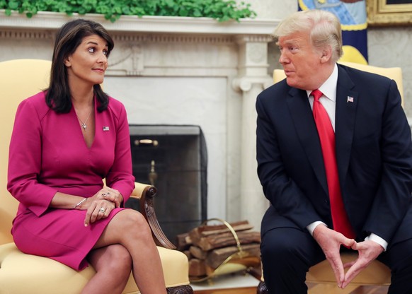 U.S. President Donald Trump talks with U.N. Ambassador Nikki Haley in the Oval Office of the White House after it was announced the president had accepted the Haley&#039;s resignation in Washington, U ...