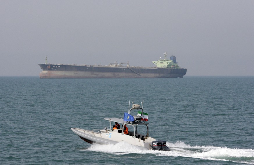 FILE-- In this July 2, 2012 file photo, an Iranian Revolutionary Guard speedboat moves in the Persian Gulf while an oil tanker is seen in background. As nuclear deal threatened, Iran?s politics increa ...