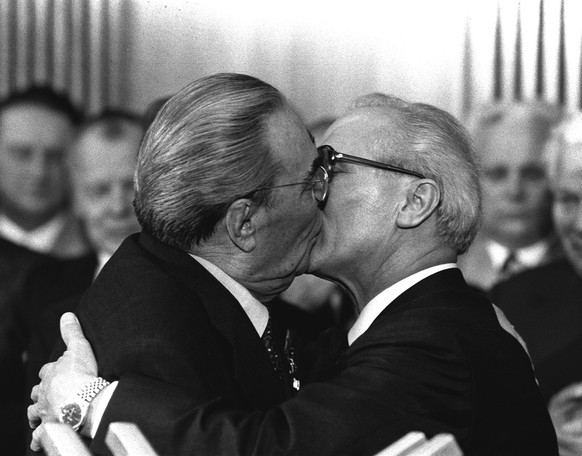 BER6 Berlin, East Germany, Oct. 4, 1979 - Soviet President Leonid Brezhnev and East German leader Erich Honecker change kisses after Brezhnev was honored with the title &quot;Hero of the German Democr ...